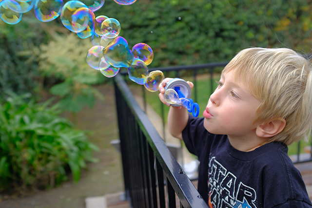 Grandson blowing bubbles